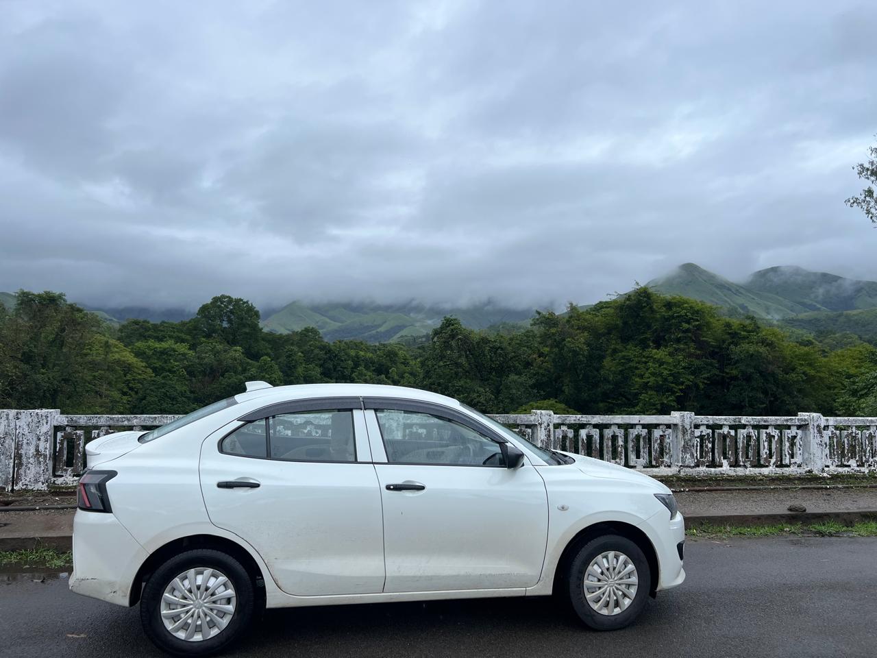 Veerabadra Travels Swift Dzire Sedan side view on bridge