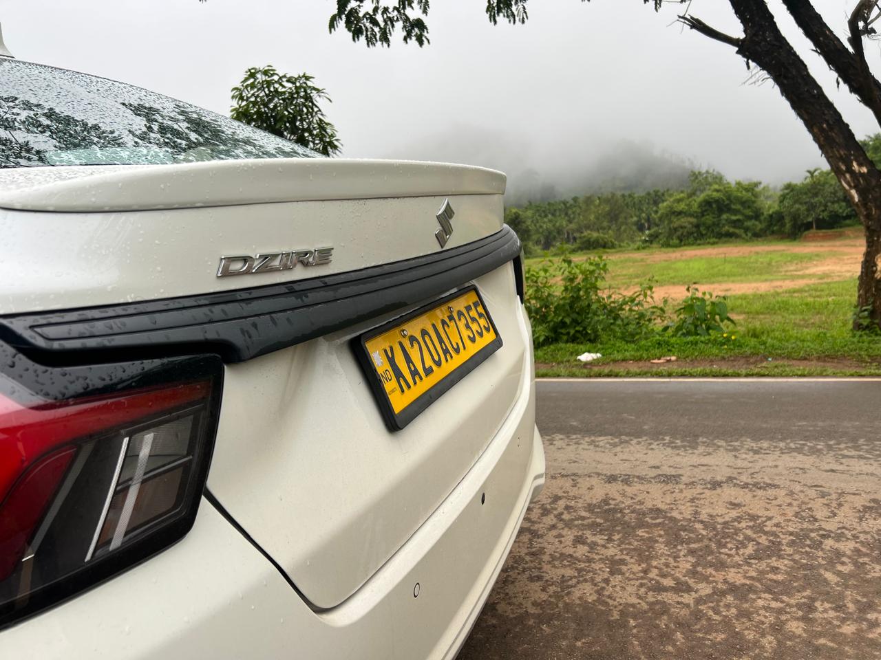 Swift Dzire Sedan close up on a misty hill road